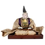 A Japanese Samurai doll, Meiji period, depicting a Chief of Arms in yellow ground brocade robe,