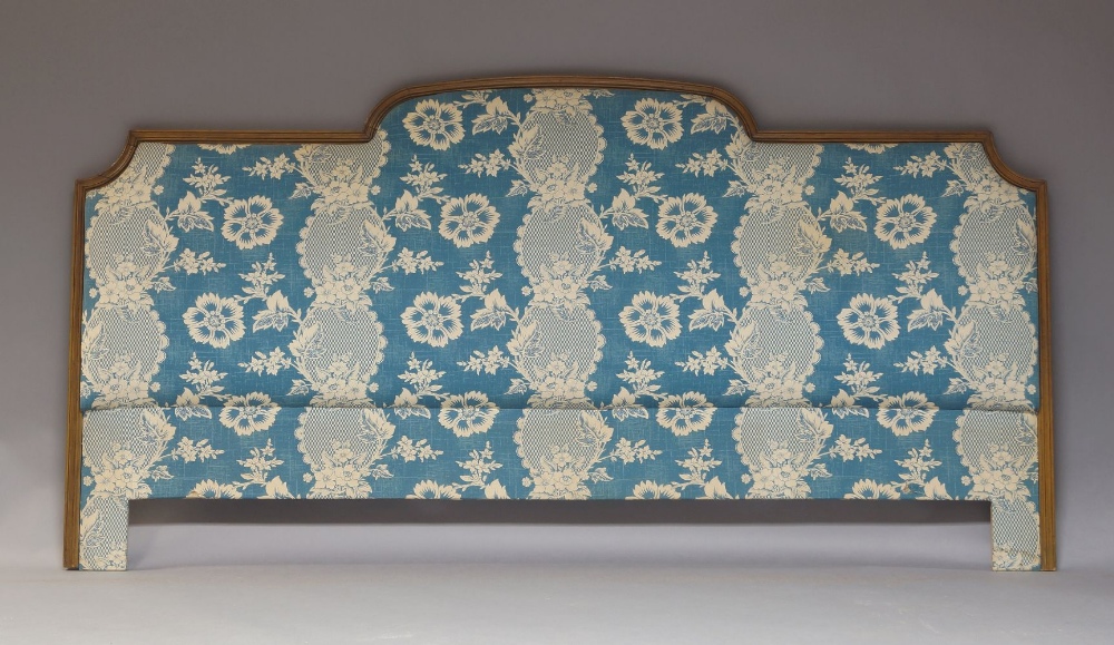 A French walnut double bed headboard, 20th century, with blue and cream floral upholstery, 105cm