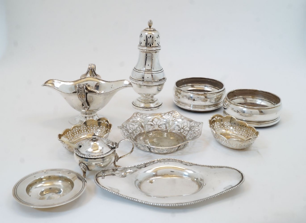 A collection of silver, to include: a twin handled sauce boat and stand, Chester, 1906, Barker