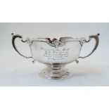 A silver twin handled cup, by Mappin & Webb, Sheffield, 1975, with scalloped rim on circular foot,