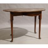 A George III mahogany drop leaf table, circa 1770, the oval top raised on square block and