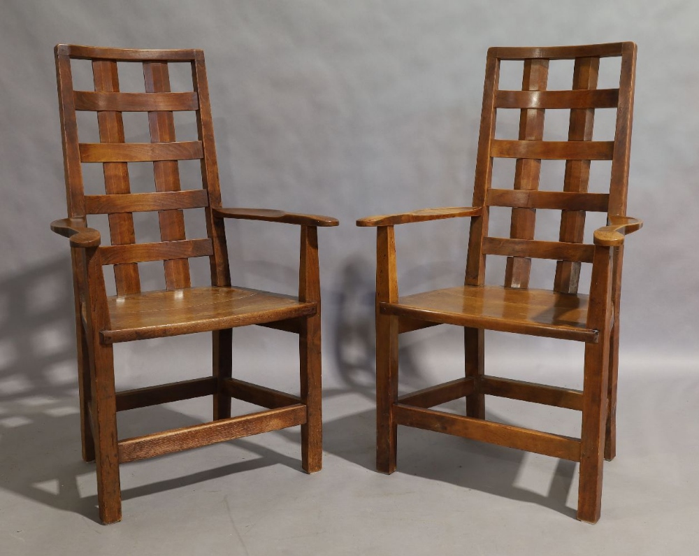 A pair of Arts and Crafts oak and elm open elbow chairs, late 19th century, with slatted backrest,