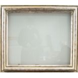 An English Silvered Glazed Moulding Frame, circa 1930s, with ogee sight and top edge, bears