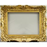 An English Gilded Composition Louis XV Style Swept Frame, mid-late 19th century, with cavetto sight,