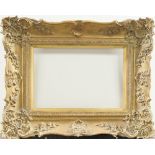 A Gilded Composition Louis XV Style Swept Frame, late 20th century, with cavetto sight, stiff leaf