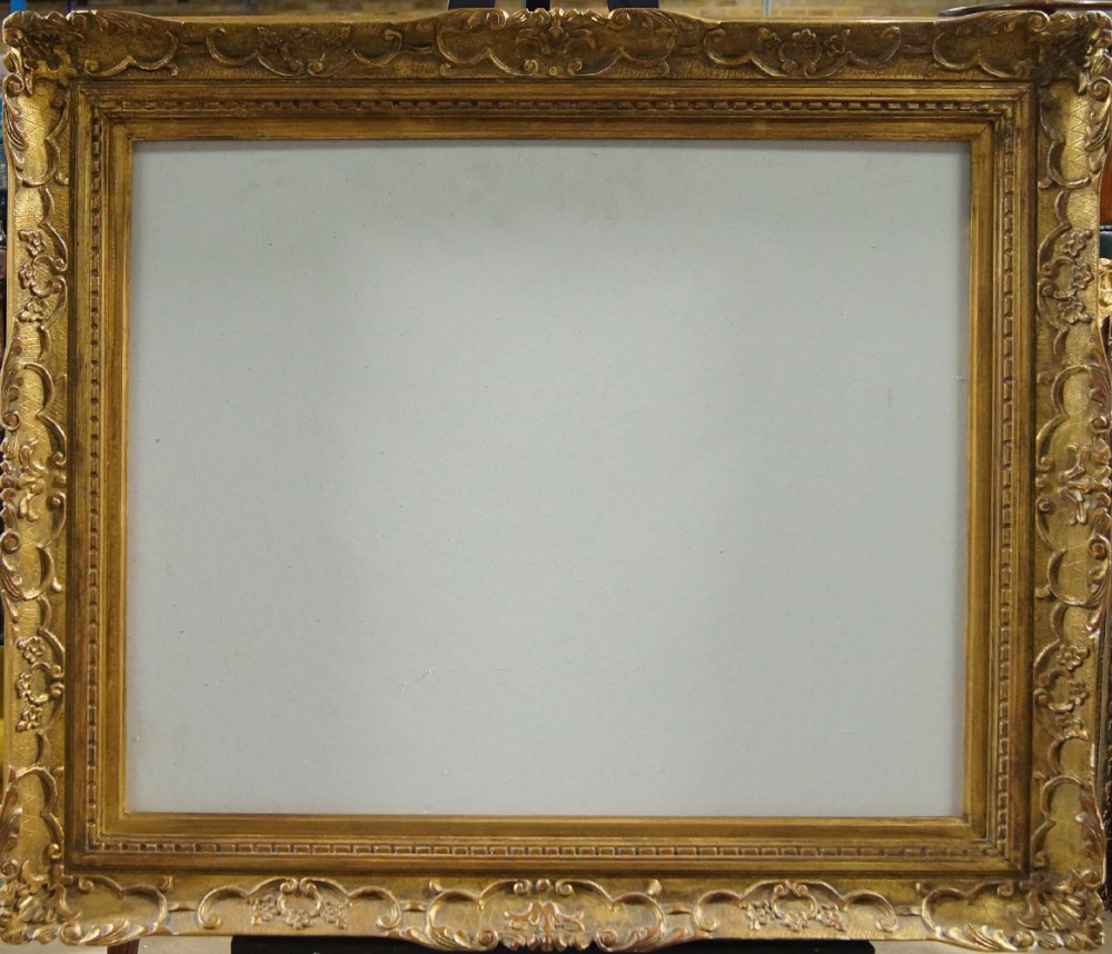 A Carved and Gilded Provincial Louis XIV Style Swept Frame, mid-20th century, with cavetto sight,