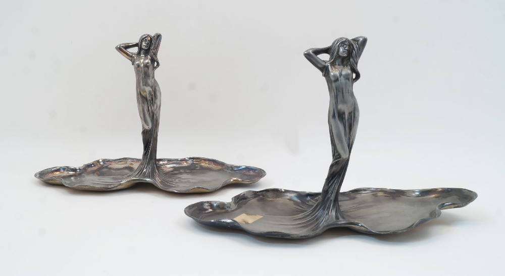 Two WMF Art Nouveau figural pewter dishes, 20th century, each designed as a maiden emerging from a