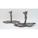 Two WMF Art Nouveau figural pewter dishes, 20th century, each designed as a maiden emerging from a