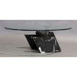 An Artedi coffee table, circular glass top raised on black marble base, 33cm high, 102cm diameter