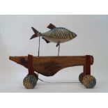 British School, 20th century- Fish; painted carved wood and metal on wooden wheels, 31 x 41 x