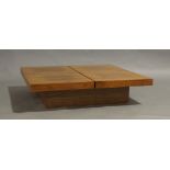 A Contemporary walnut veneered low coffee table, with sliding mechanism enclosing storage