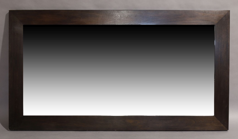A large contemporary wenge mirror, thick mahogany veneered frame set with bevelled glass plate,