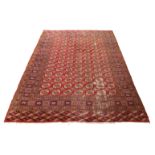 A large Bokhara carpet, third quarter 20th century, repeating gull motifs, on a red ground, conta...