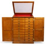 A large oak collectors cabinet