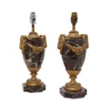 A pair of French Louis XVI style rouge marble urn lamps, late 19th century, the marble bodies wit...