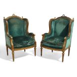 A pair of French Louis XVI style mahogany wingback armchairs