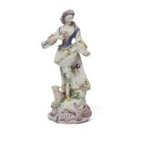 A Bow porcelain figure of a shepherdess, c.1757, modelled after the Meissen example, standing wea...