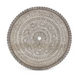 A circular filigree white metal tray