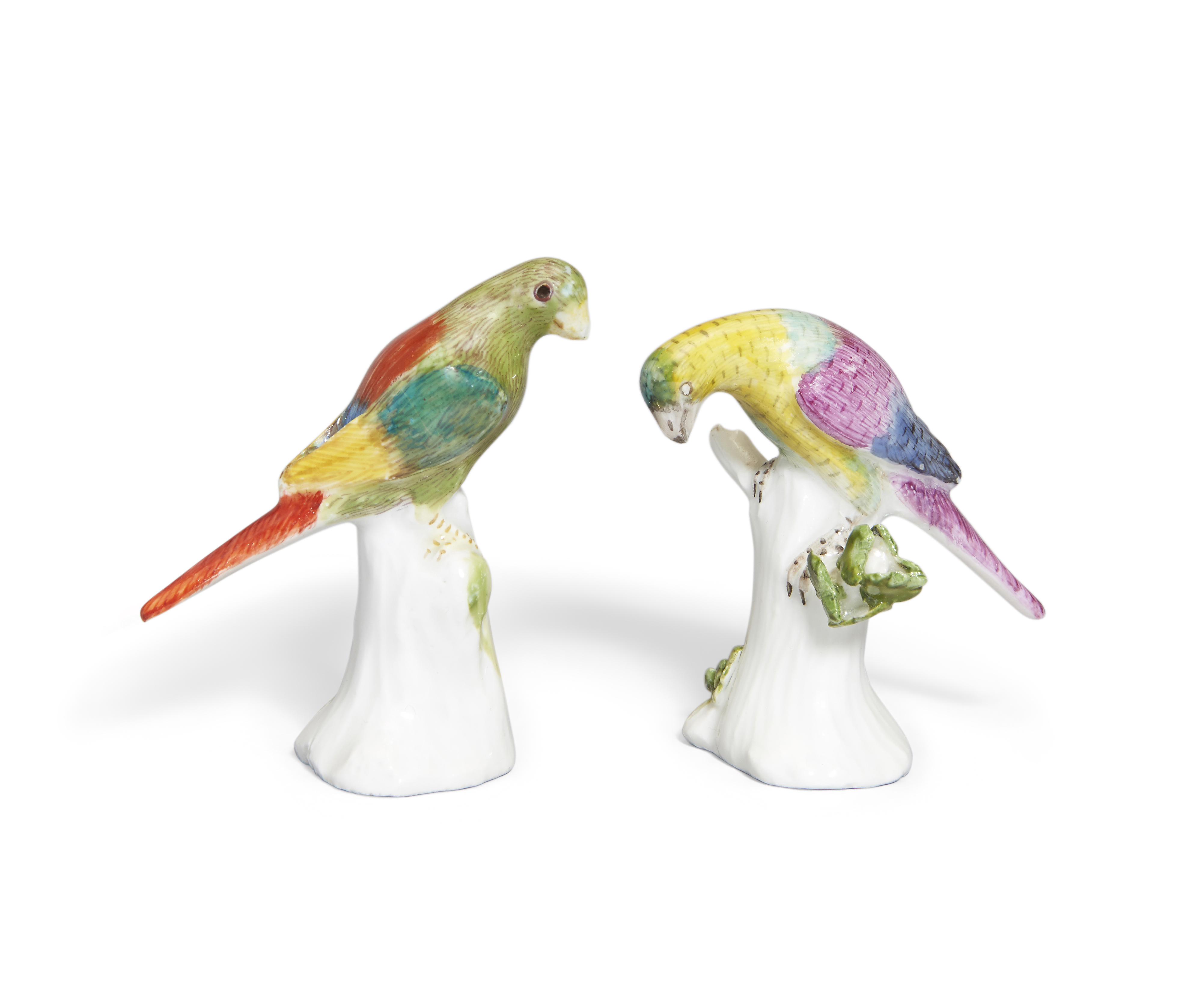 Two Meissen miniature models of parakeets, c.1741, modelled by J.J. Kändler, each perched on a tr...