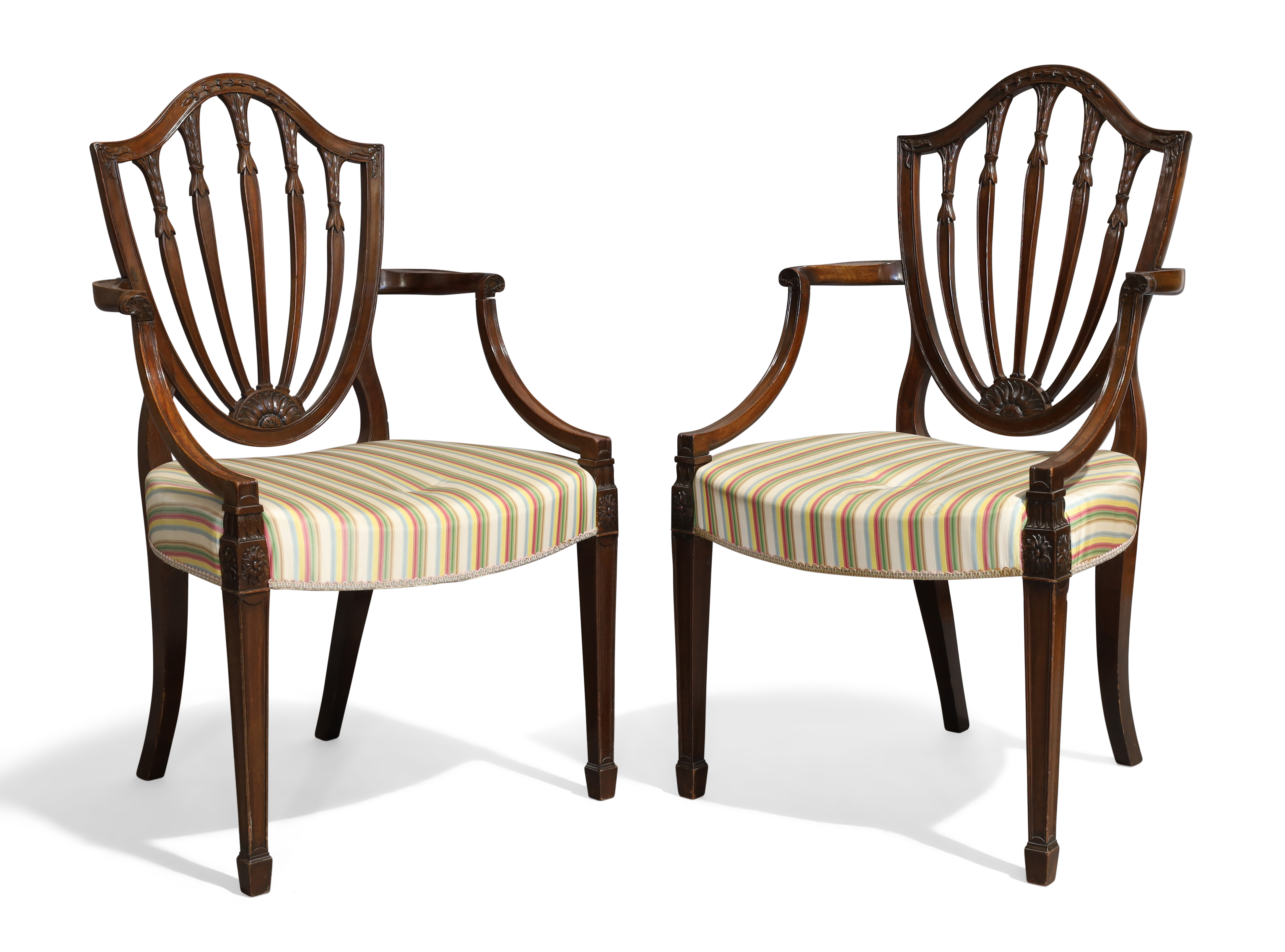 A pair of George III mahogany Hepplewhite style open elbow chairs