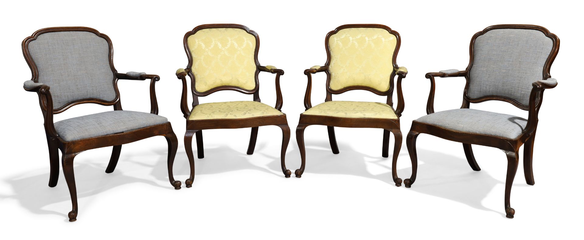 A set of four mahogany open fauteuils, late 18th century, in the French taste, two upholstered in...