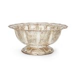 A large centrepiece bowl with pierced, fluted sides, apparently unmarked, probably Indian, the sh...