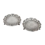 A pair of George III silver waiters, London, 1749, Hugh Mills, of shaped circular form with a cas...