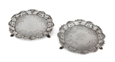 A pair of George III silver waiters, London, 1749, Hugh Mills, of shaped circular form with a cas...