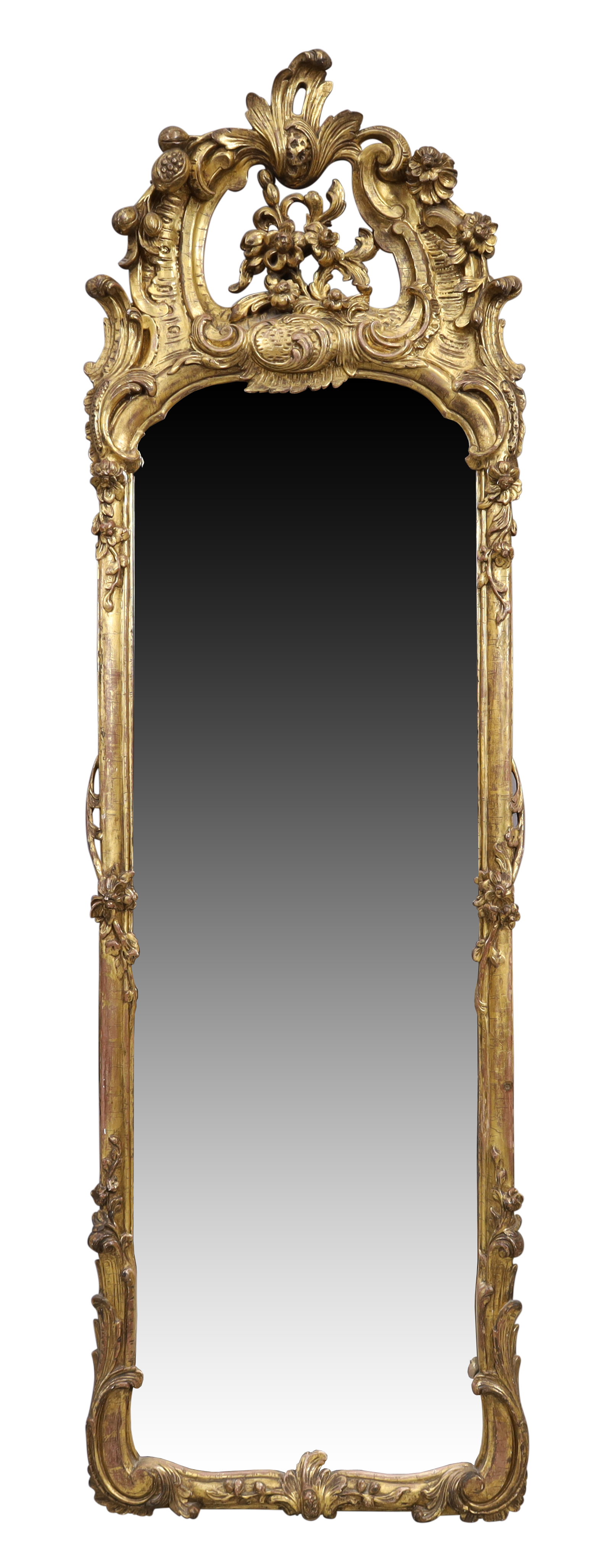 A French rococo gilt wood pier mirror, last quarter 19th century, the floral carved crest with C ...