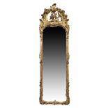A French rococo gilt wood pier mirror, last quarter 19th century, the floral carved crest with C ...
