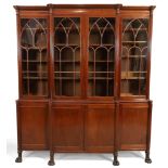 A George IV mahogany breakfront library bookcase, c.1820, the moulded cornice above four Gothic a...