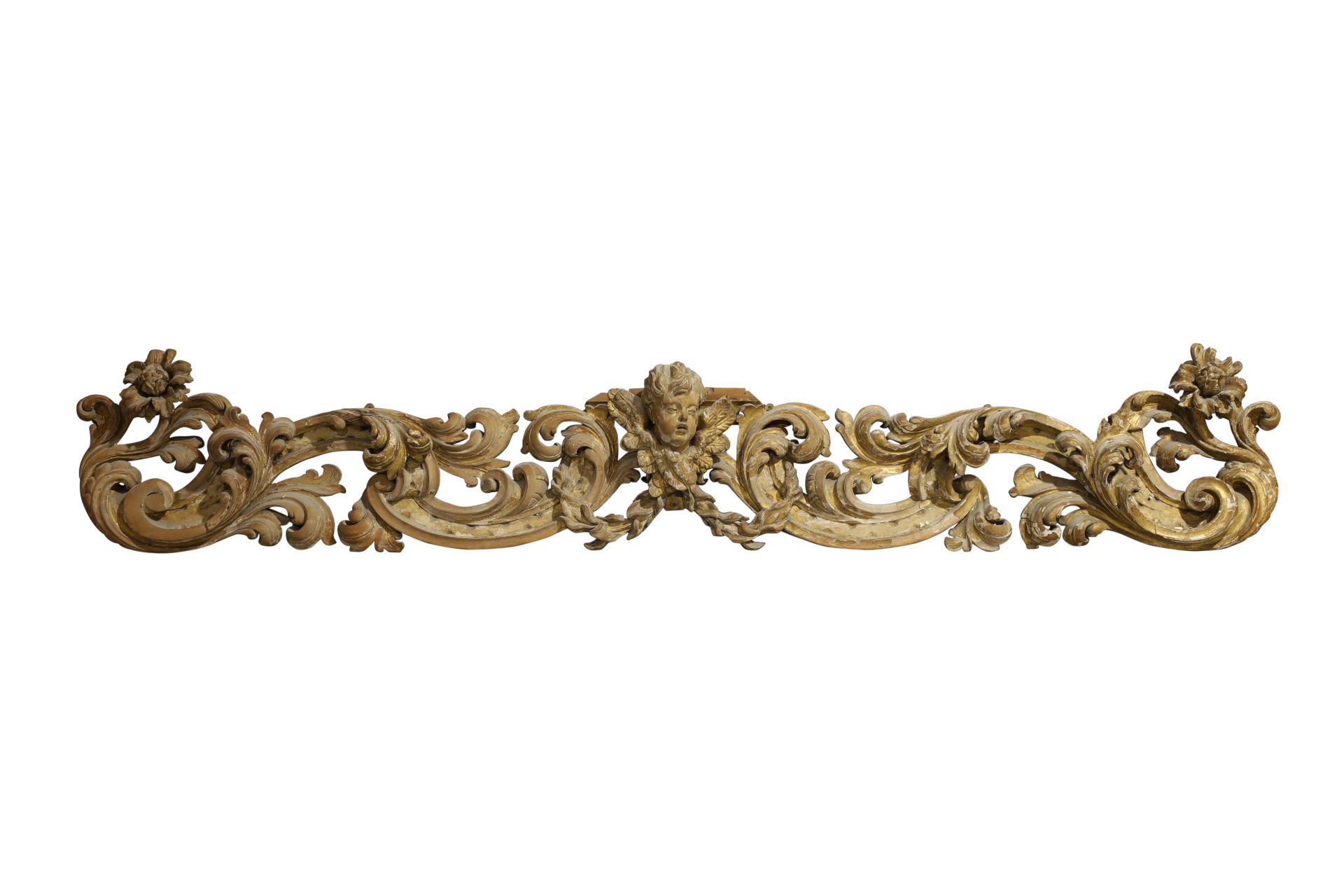 A large Italian carved parcel gilt frieze, 19th century, centred by a winged mask putto flanked b...