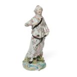 A Derby porcelain figure of a Turk, c.1780, modelled standing, wearing flowered robes and a loose...