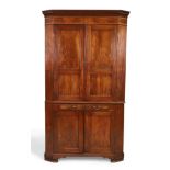 A George III mahogany standing corner cupboard