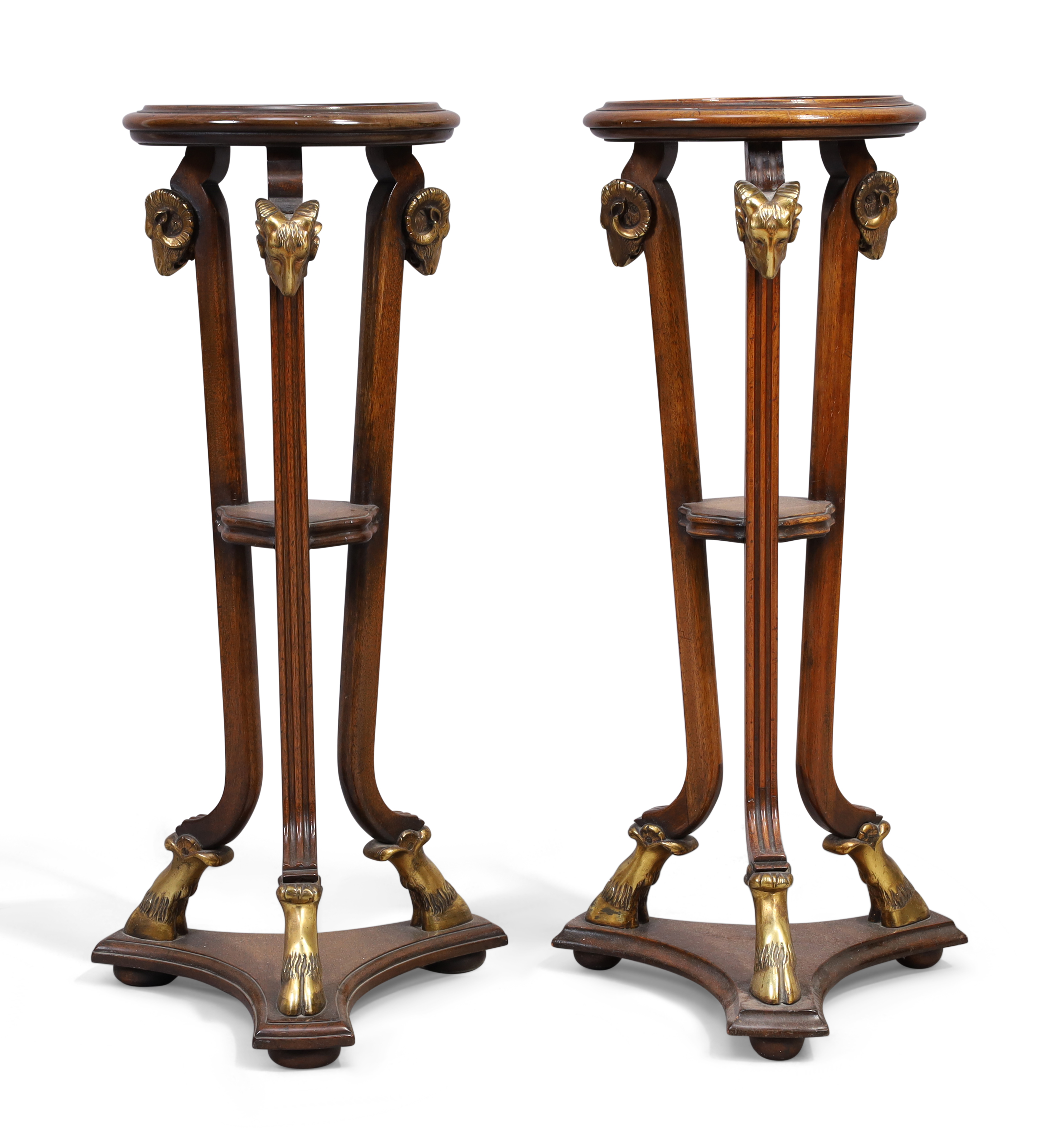 A pair of Adam style mahogany jardiniere stands, late 20th century, the circular tops raised on t...