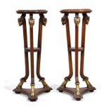 A pair of Adam style mahogany jardiniere stands, late 20th century, the circular tops raised on t...