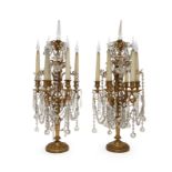 A pair of French gilt-bronze and cut glass six-light candelabra, late 19th century, each with scr...