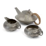 Archibald Knox (1864-1933) for Liberty & Co Three-piece tea service, circa 1900 Pewter, woven re...