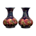 William Moorcroft (1872-1945) Pair of vases in pomegranate pattern, 1916-1918 Glazed earthenware...