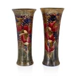 William Moorcroft (1872-1945) Pair of large Celadon Pomegranate trumpet vases, 1912 Glazed earth...