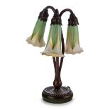 Tiffany Studios Three branch 'Lily' table lamp with Quezal shades, circa 1910 Bronze, glass Unde...