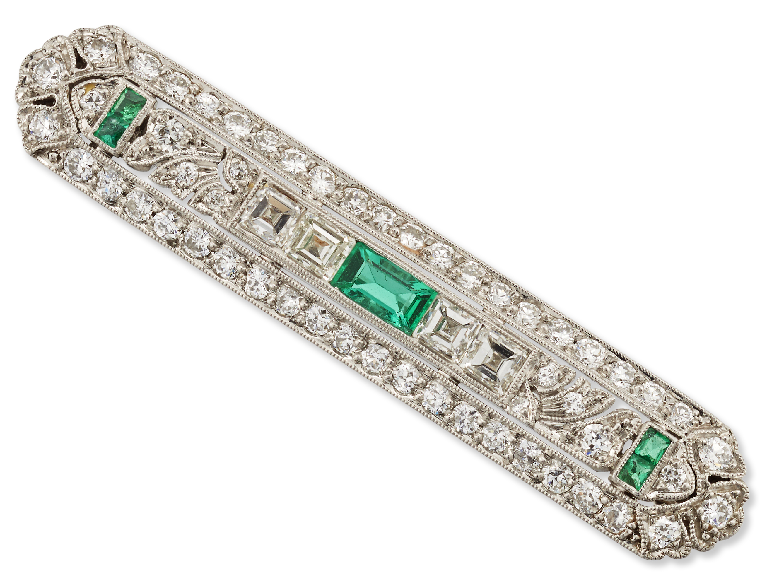 An early 20th century platinum, emerald and diamond brooch,