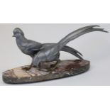 An Art Deco spelter sculpture depicting two pheasants, second-quarter 20th century, on an oval ma...