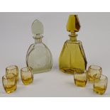 An Art Deco amber glass decanter and shot glass set, of angular octagonal form tapering into hexa...