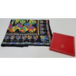 A Must de Cartier silk scarf, decorated against a black background in flamingo and jewel design, ...