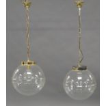A pair of pendant ceiling lights, late 20th century, each with clear and bubbled spherical glass ...