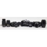 A group of Olympus cameras and lenses, to include: an OM-2 SLR camera no. 1082453, with Zuiko 50m...