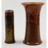 An Ault pottery vase with tube lined tree decoration in shades of brown, and a Royal Doulton cyli...