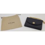 A Céline Paris navy blue leather shoulder bag, c.1970s, gold hardware, with star ball logo inscri...