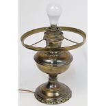 A brass standard lamp, early 20th century, with oil burned and reservoir, on tripod base, convert...